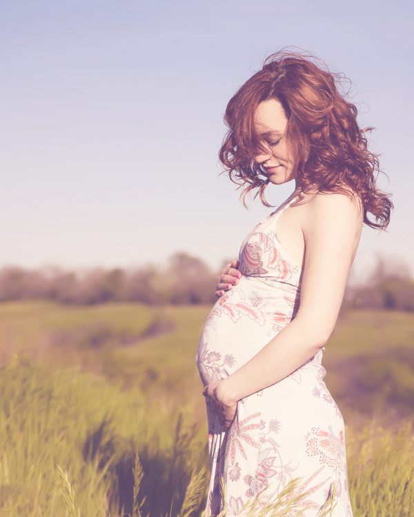 Young happy pregnant woman relaxing and enjoying life in nature. Young happy pregnant woman relaxing and enjoying life in nature.